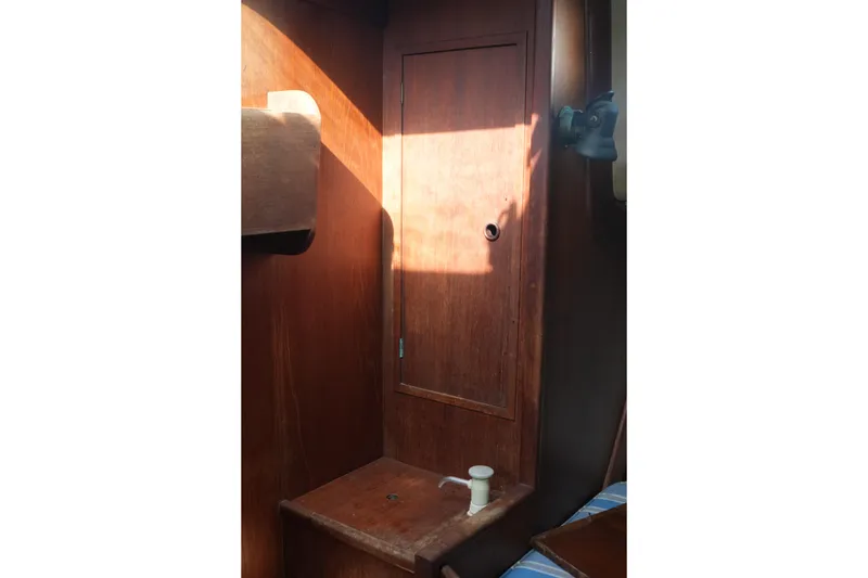 Slide: The Image of Interior of 1977 Fisher 37 MS sailboat with wooden cabinetry and seating. - 35