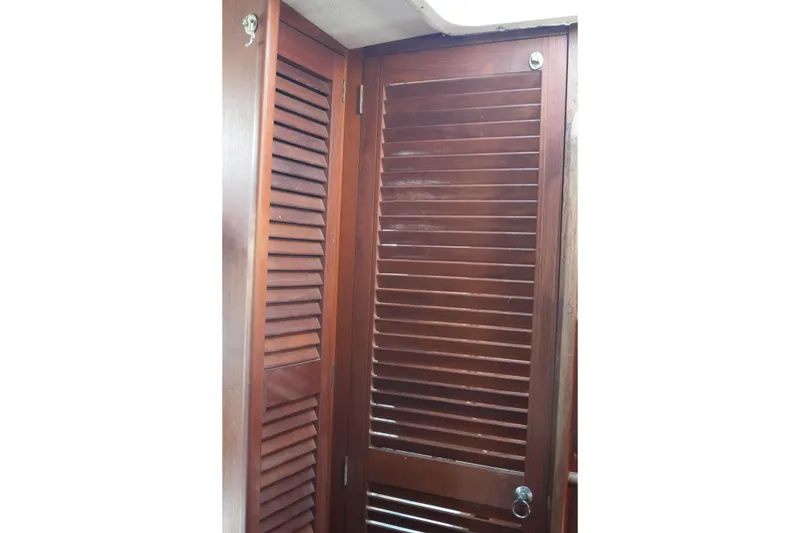 Slide: The Image of Wooden louvered door inside 1977 Fisher 37 MS boat cabin. - 37
