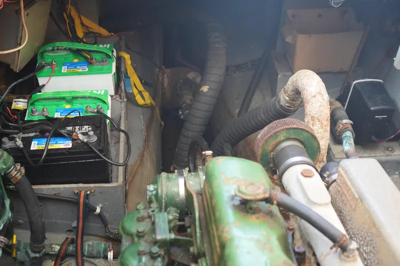 Slide: The Image of Engine compartment of a 1977 Fisher 37 MS with batteries and mechanical components. - 41