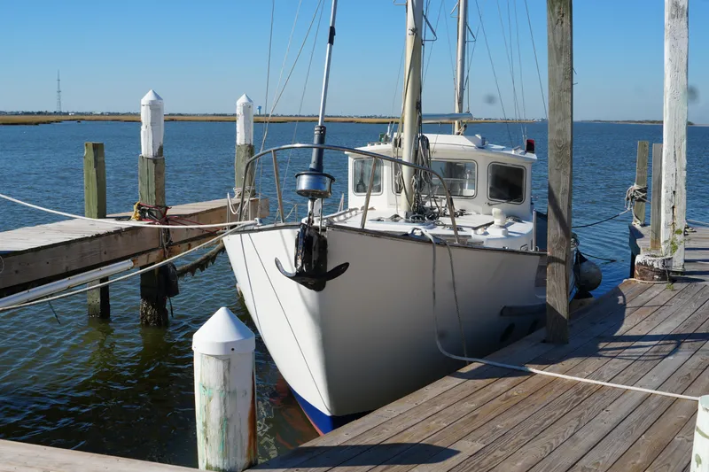 Slide: The Image of 1977 Fisher 37 MS sailboat docked at a wooden pier on a sunny day. - 5