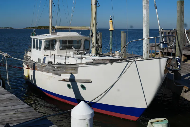 Slide: The Image of 1977 Fisher 37 MS sailboat docked at a marina on a sunny day. - 6