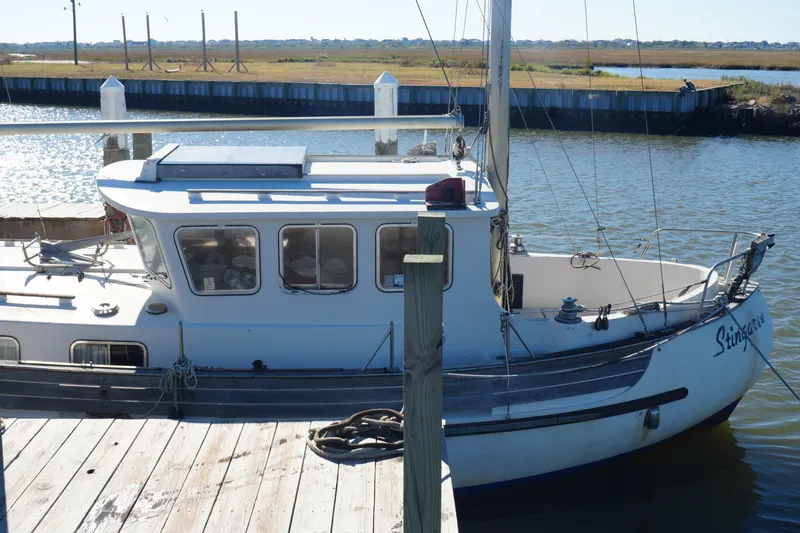 Slide: The Image of 1977 Fisher 37 MS sailboat docked at a marina, calm water, sunny day. - 7