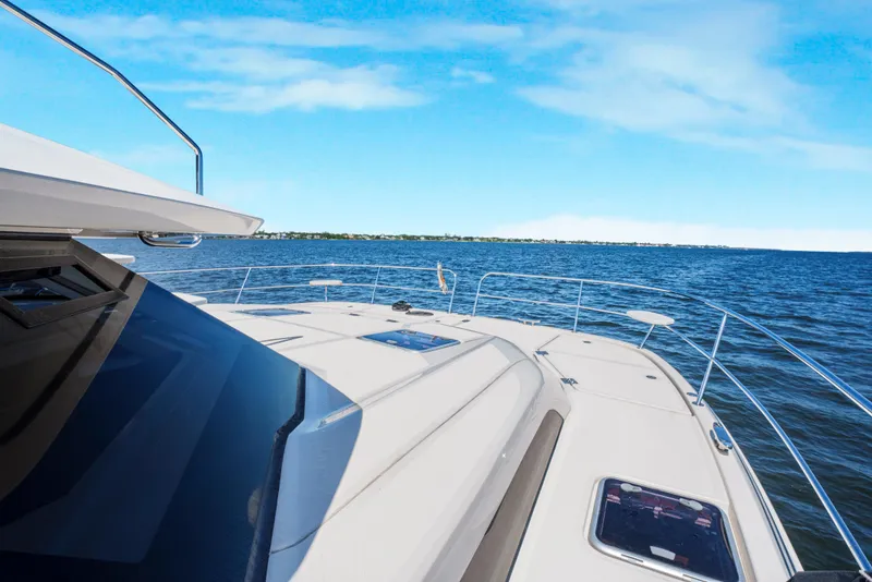 Slide: The Image of Aquila 44 Yacht 2017 cruising on open water under clear blue skies. - 10