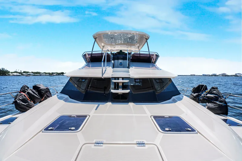 Slide: The Image of 2017 Aquila 44 Yacht on open water under clear blue sky. - 11