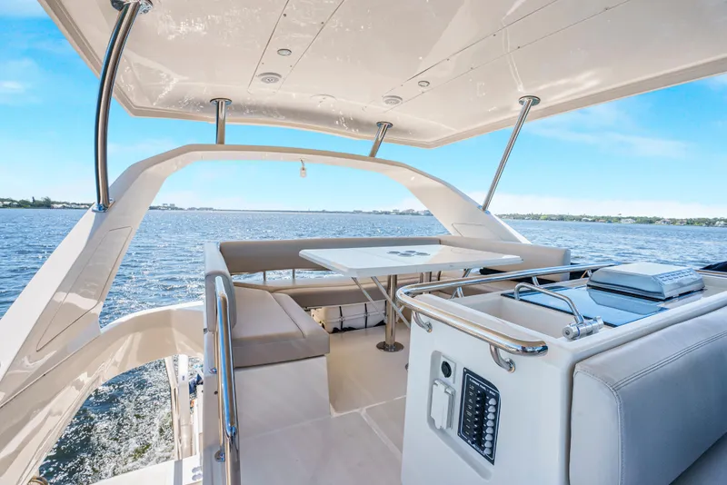 Slide: The Image of Aquila 44 Yacht 2017, spacious deck with seating, cruising on open water. - 12