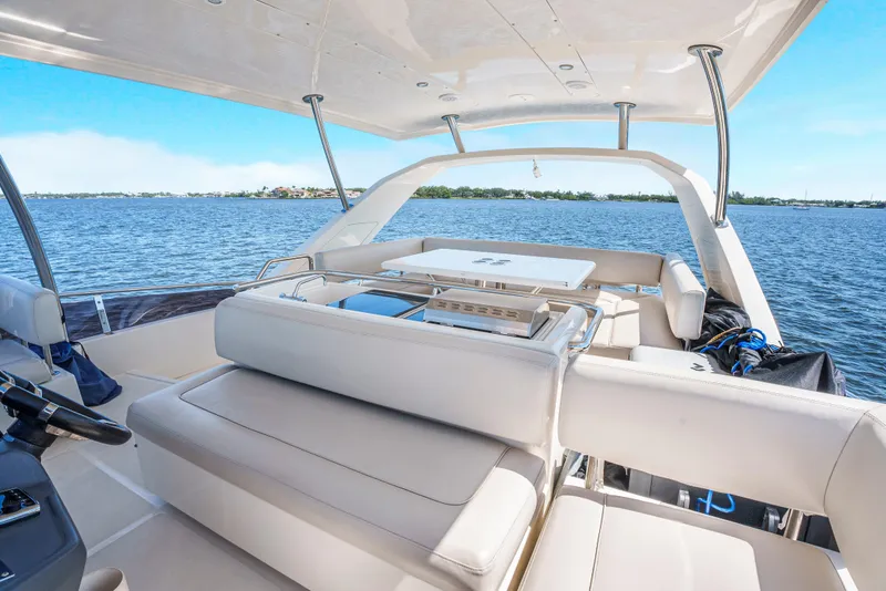 Slide: The Image of Luxurious 2017 Aquila 44 Yacht interior with seating, overlooking serene blue waters. - 15
