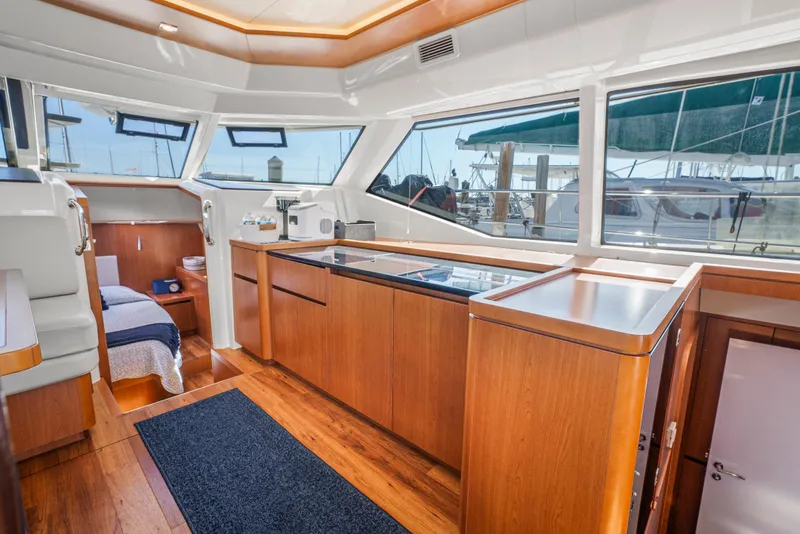 Slide: The Image of Luxurious interior of 2017 Aquila 44 Yacht with modern wood finishes and large windows. - 17