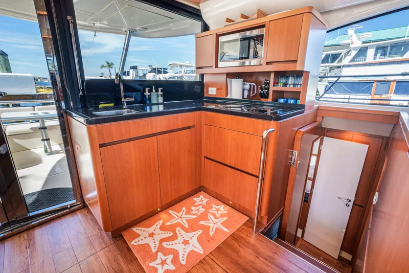 Slide: The Image of Luxurious kitchen interior of 2017 Aquila 44 Yacht with wood cabinetry and modern appliances. - 18