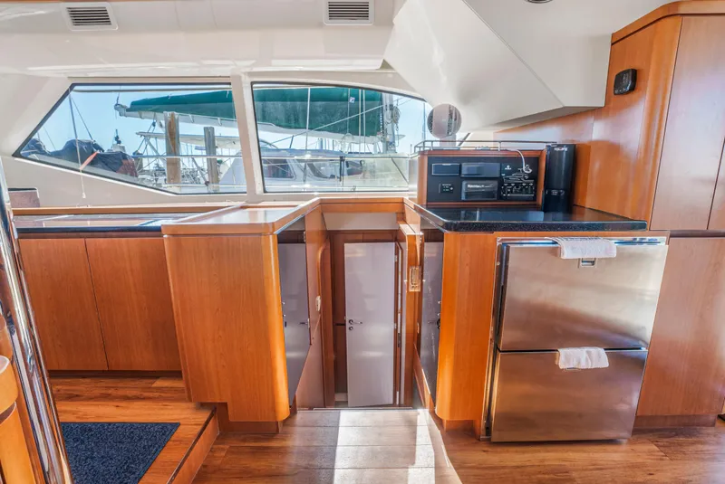 Slide: The Image of Interior of 2017 Aquila 44 Yacht with modern kitchen and wood cabinetry. - 19
