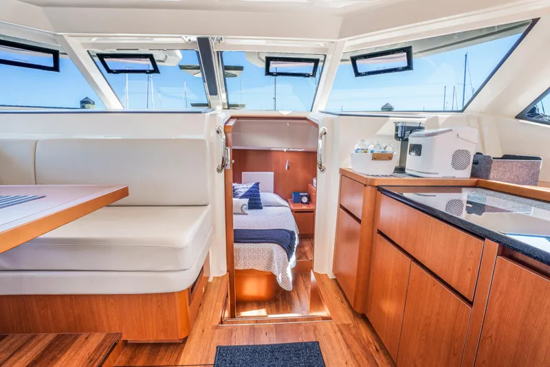 Slide: The Image of Interior of 2017 Aquila 44 Yacht featuring dining area, kitchenette, and cozy cabin. - 21