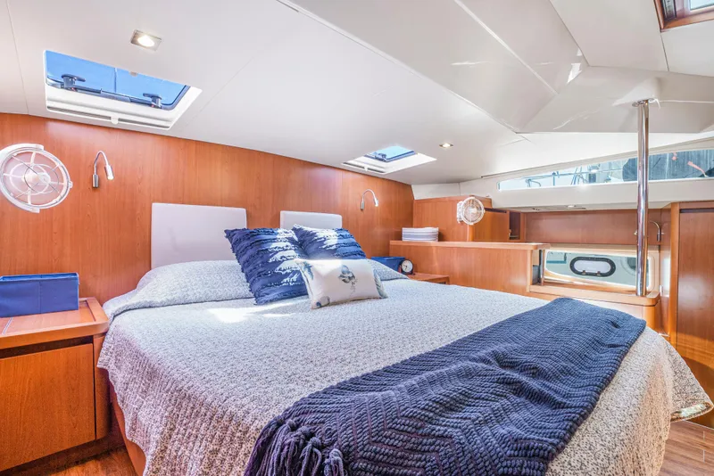 Slide: The Image of Luxurious cabin interior of 2017 Aquila 44 Yacht with cozy bed and elegant wood finish. - 25