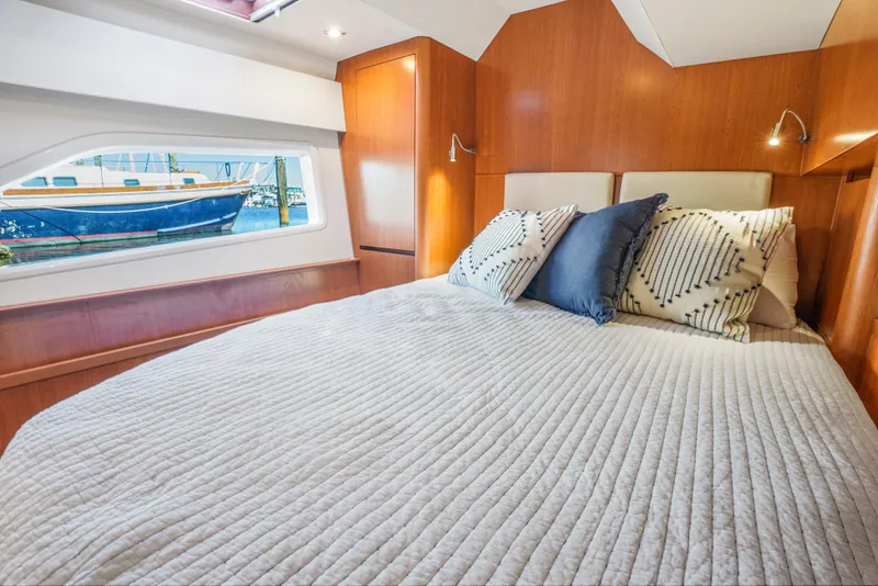 Slide: The Image of Luxurious cabin interior of 2017 Aquila 44 Yacht with cozy bedding and scenic window view. - 26