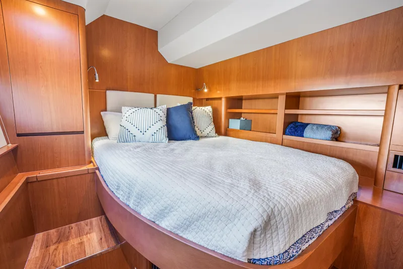 Slide: The Image of Luxurious bedroom interior of 2017 Aquila 44 Yacht with cozy bedding and wooden accents. - 28