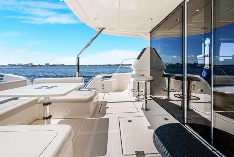 Slide: The Image of Aquila 44 Yacht 2017 deck with seating, table, and ocean view. - 6
