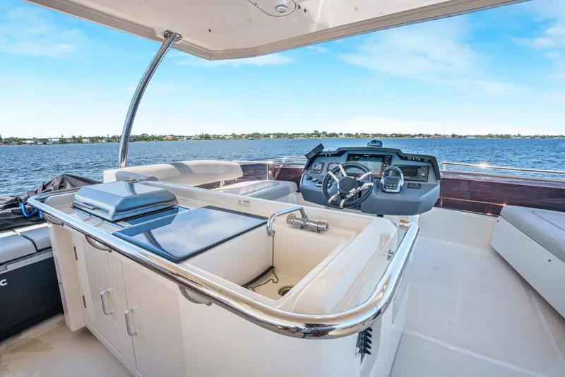 Slide: The Image of 2017 Aquila 44 Yacht helm with modern controls and ocean view. - 7