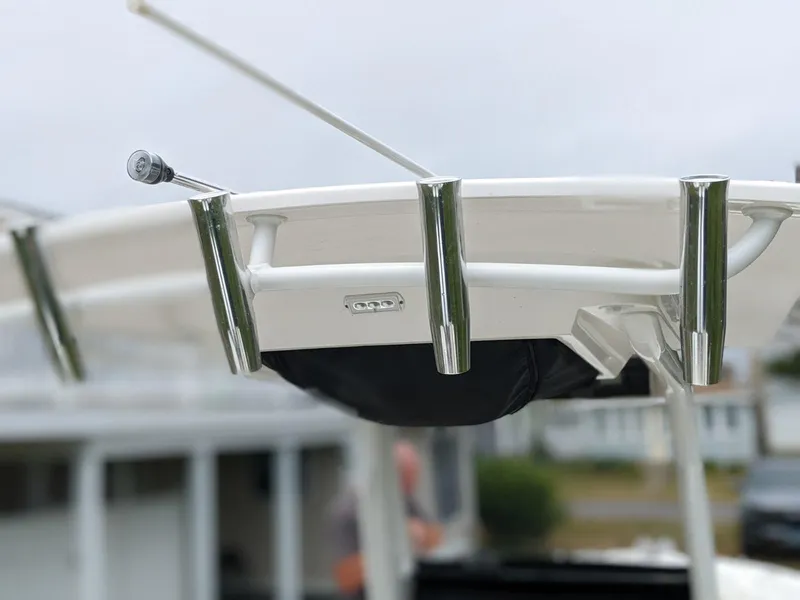 Slide: The Image of 2021 Edgewater 262 CC boat with rod holders and antenna on the T-top. - 11