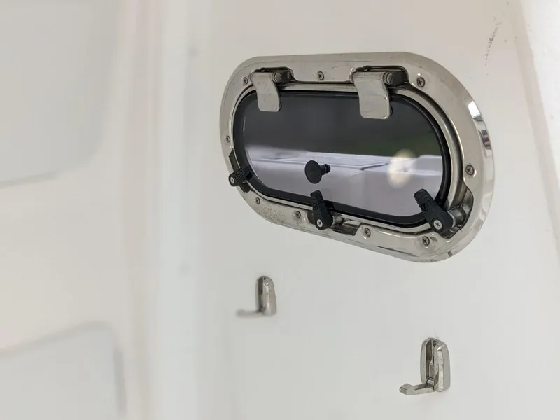 Slide: The Image of Porthole window on 2021 Edgewater 262 CC boat interior. - 17