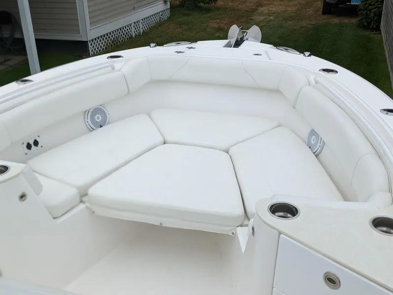 Slide: The Image of 2021 Edgewater 262 CC boat with spacious white seating area and cup holders. - 19