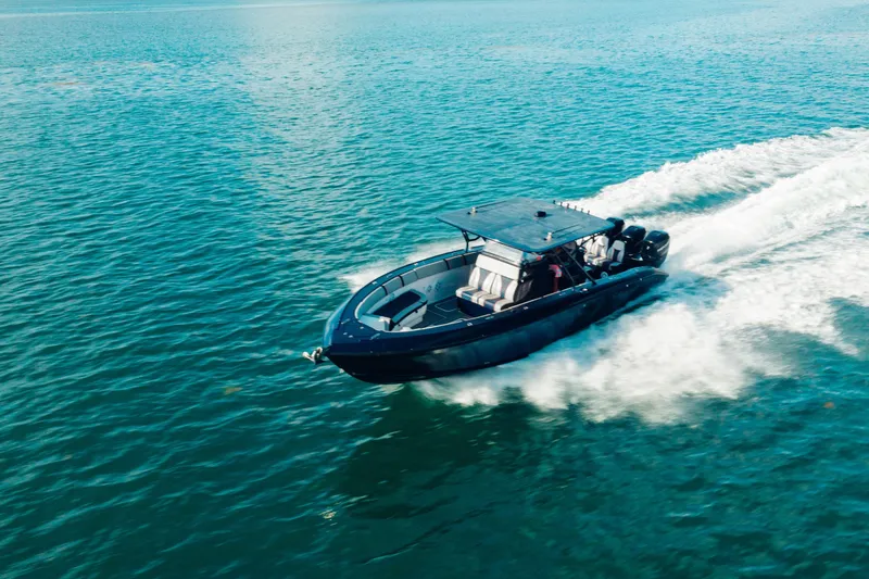 Slide: The Image of 2014 Midnight Express 37’ Open boat cruising on blue ocean waters. - 1