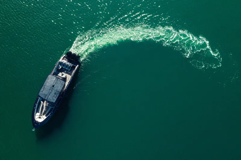Slide: The Image of Aerial view of 2014 Midnight Express 37’ Open boat cruising in clear green water. - 10