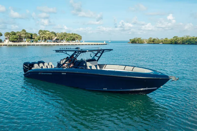 Slide: The Image of 2014 Midnight Express 37’ Open boat on calm blue water, clear sky background. - 13