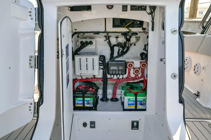 Slide: The Image of Electrical compartment of a 2014 Midnight Express 37’ Open boat, showing batteries and wiring. - 22