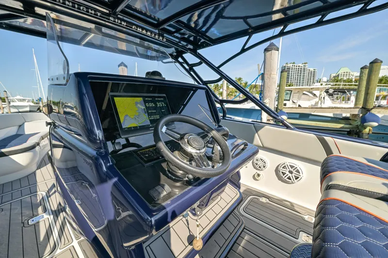 Slide: The Image of 2014 Midnight Express 37’ Open boat interior with steering wheel and navigation display. - 24