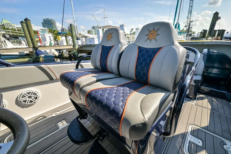 Slide: The Image of 2014 Midnight Express 37’ Open boat with stylish, cushioned seats at a marina. - 28