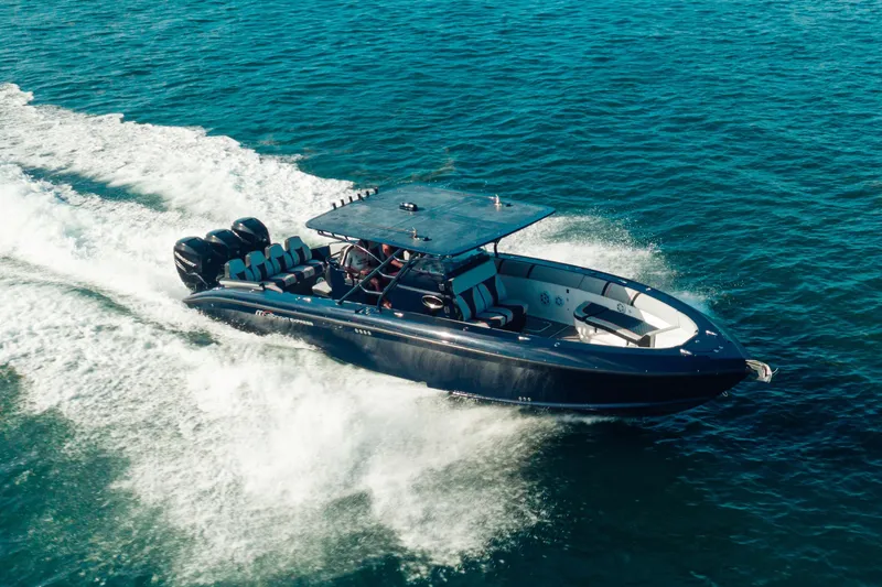 Slide: The Image of 2014 Midnight Express 37’ Open boat cruising on blue ocean waters. - 3