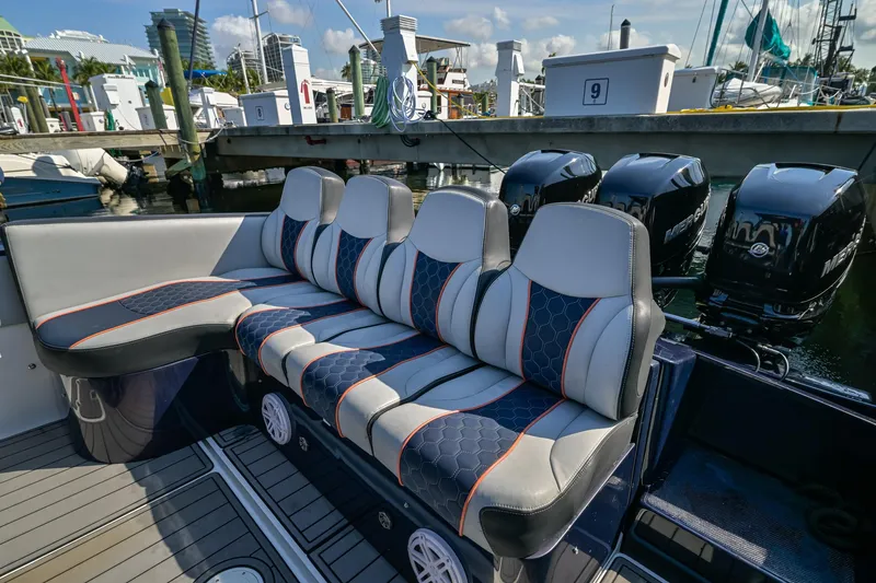 Slide: The Image of 2014 Midnight Express 37’ Open boat with stylish seating and powerful outboard engines at a marina. - 31