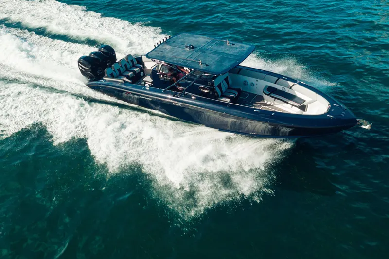 Slide: The Image of 2014 Midnight Express 37’ Open boat cruising on blue ocean waters. - 5