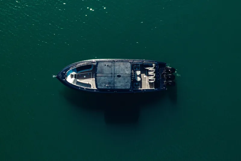 Slide: The Image of Aerial view of 2014 Midnight Express 37’ Open boat on calm water. - 9