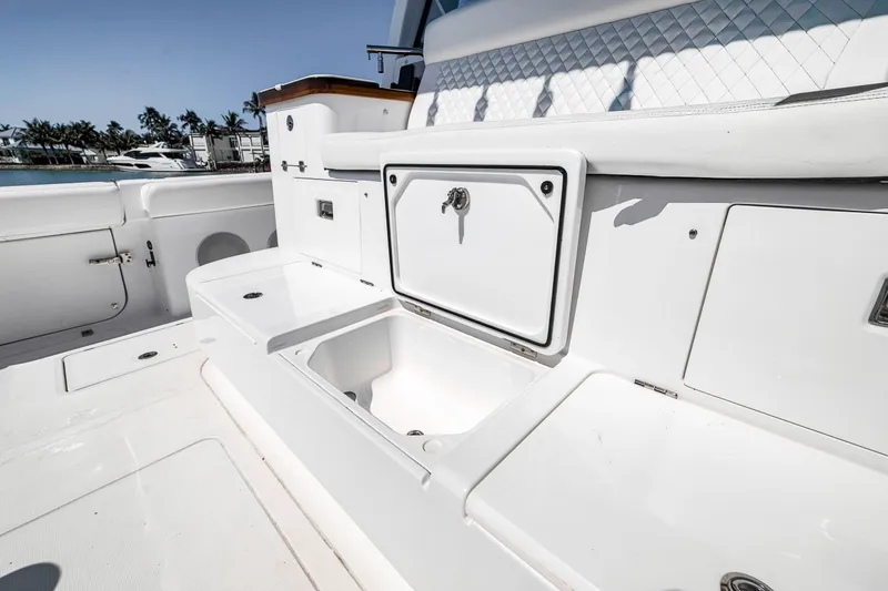Slide: The Image of 2024 HCB 65 Estrella boat interior with storage and seating area. - 49