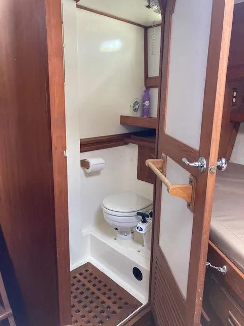 Slide: The Image of 1986 Albin 36 Trawler bathroom with wooden accents and compact design. - 15