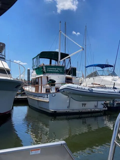 Slide: The Image of 1986 Albin 36 Trawler docked at marina under clear blue sky. - 3