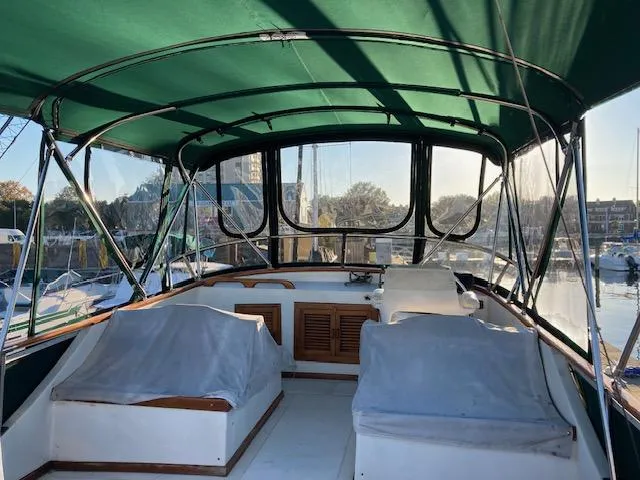 Slide: The Image of 1986 Albin 36 Trawler with green canopy, docked at marina. - 7