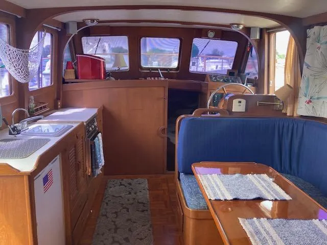 Slide: The Image of Interior of 1986 Albin 36 Trawler with kitchen, dining area, and helm station. - 8