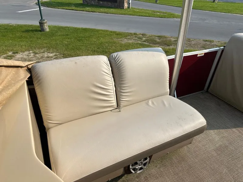 Slide: The Image of Beige seating on 2017 Godfrey Sweetwater 2386 CC boat, with outdoor view. - 15