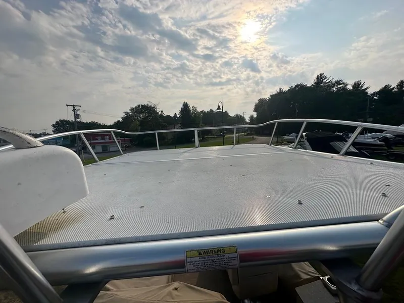 Slide: The Image of 2017 Godfrey Sweetwater 2386 CC boat deck under a cloudy sky with sun peeking through. - 20