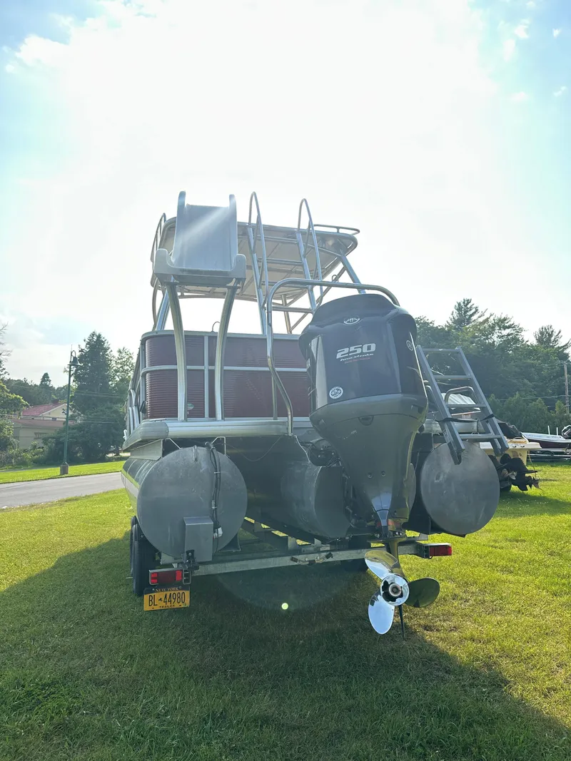 Slide: The Image of 2017 Godfrey Sweetwater 2386 CC pontoon boat with powerful engine, parked on grass. - 24