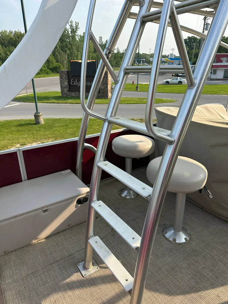 Slide: The Image of 2017 Godfrey Sweetwater 2386 CC boat interior with ladder and seating. - 27