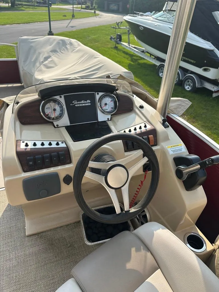 Slide: The Image of 2017 Godfrey Sweetwater 2386 CC boat dashboard with steering wheel and gauges. - 9