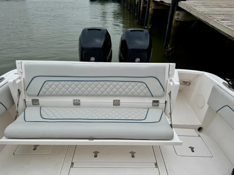 Slide: The Image of 2018 Intrepid 327 Center Console boat with dual engines and cushioned seating. - 12