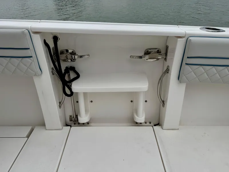 Slide: The Image of 2018 Intrepid 327 Center Console boat interior with seating and storage features. - 18