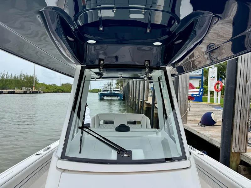 Slide: The Image of 2018 Intrepid 327 Center Console boat docked by a marina. - 20