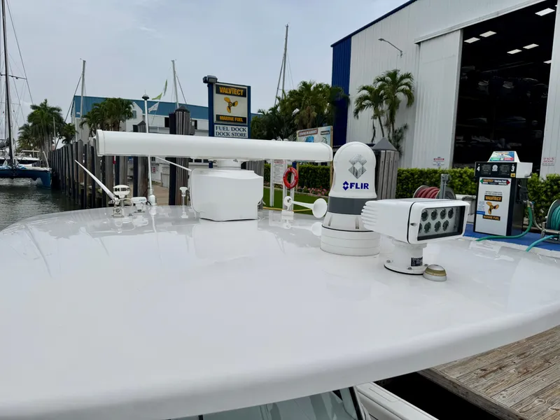 Slide: The Image of 2018 Intrepid 327 Center Console with advanced navigation equipment at a marina. - 21