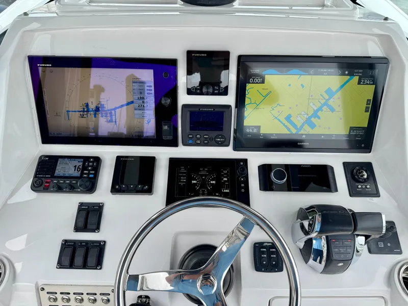 Slide: The Image of 2018 Intrepid 327 Center Console dashboard with navigation screens and controls. - 25