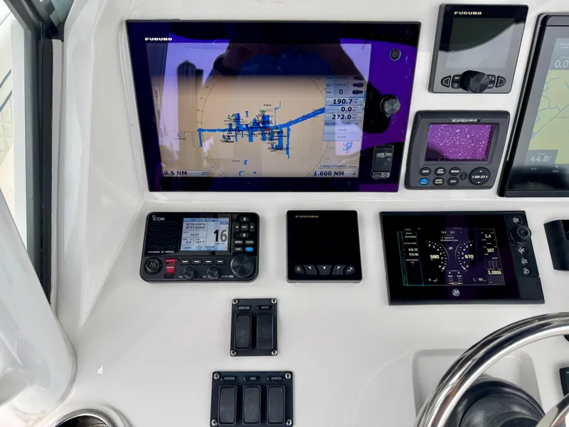 Slide: The Image of Control panel of a 2018 Intrepid 327 Center Console with navigation and communication systems. - 26