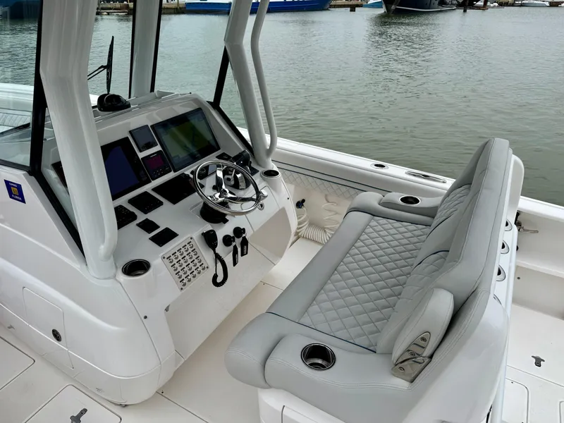 Slide: The Image of 2018 Intrepid 327 Center Console boat interior with steering wheel and seating. - 3