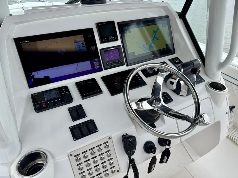 Slide: The Image of 2018 Intrepid 327 Center Console dashboard with navigation screens and steering wheel. - 6
